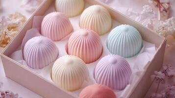 Colorful pastel pastries arranged in a decorative box with delicate floral accents on a light background photo