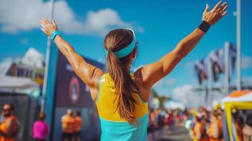 Runner celebrates victory after completing a challenging race at a popular outdoor event under a clear blue sky photo
