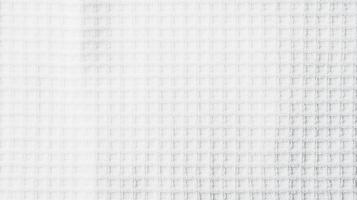 Textured white fabric with a woven pattern creating a soft and airy appearance suitable for various design and craft projects photo