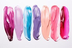 Set of multicolored smears of nail polish isolated on white background. photo