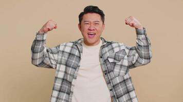 Happy man looking confident showing biceps feeling power strength to fight for rights success win video