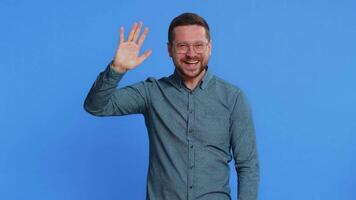 Happy man smiling friendly waving hands gesturing hello greeting or goodbye, meeting invitation video