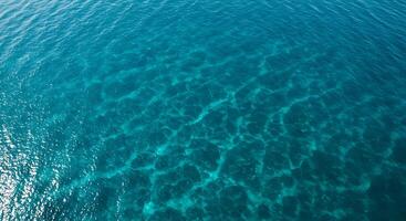 Turquoise Ocean Water Texture Sparkling in Sunlight From Above View photo