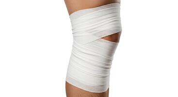 Knee Wrappped with Medical Bandage for Support and Injury Recovery photo
