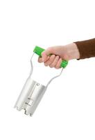 Hand holding a bulb planter tool with a green handle, isolated on white background. photo