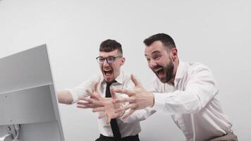 Two happy business men in the office rejoicing and showing enthusiasm for the work they have done. Successful online business and startup. The concept of winning and profits video