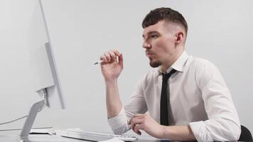 A business man receives a positive message on his phone while working at his computer. The concept of financial income, The concept of winning and profits. Financial reward. Completion of a deal video