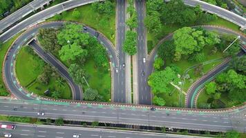 A freeway with a large bridge over it and a city in the background 1 video