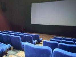 Empty rows of seats in the hall for a large number of people. Cinema and theatre hall for watching performances. photo