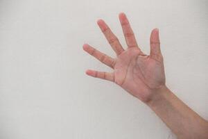 Close-up of hand showing number five gesture isolated on white background. photo