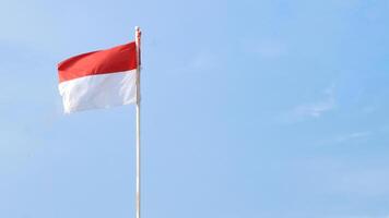 Indonesian flag fluttering in the wind with dark clouds in the background photo