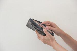 Hand taking rupiah money from brown wallet, white background, photo