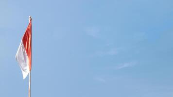Indonesian flag fluttering in the wind with dark clouds in the background, photo