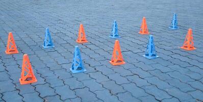 Orange cones and blue cones set up on a blue field for high school sports speed drills photo