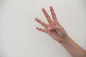 Close-up of hand showing number four gesture isolated on white background. photo