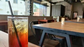 Blurred red and yellow bokeh with water drops. Condensation on glass of iced tea. photo