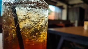 Blurred red and yellow bokeh with water drops. Condensation on glass of iced tea, photo