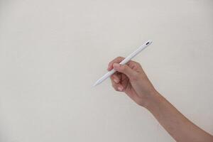 Technology Concept. One Hand using Tablet in Vertical axis with white stylus or pen and free screen on white background and clipping path photo
