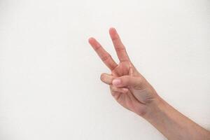Close-up of hand showing number two gesture isolated on white background. photo