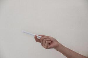 Technology Concept. One Hand using Tablet in Vertical axis with white stylus or pen and free screen photo