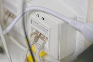 Close-up of Network Wall Socket with Ethernet Cables photo