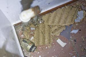 Messy Corner with Debris and Pipe photo
