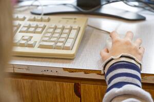 Close-up of Hand Using Computer Mouse and Keyboard photo