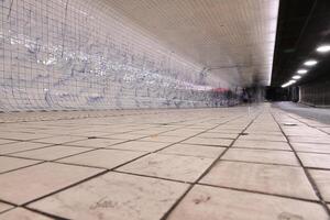 Empty Subway Tunnel with Tiled Walls photo