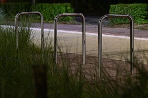 Nighttime View of Metallic Bike Racks photo