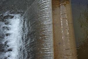 Water Cascading Over Concrete Spillway photo