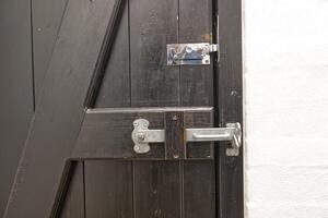Close-Up of Rustic Wooden Door with Metal Latch photo