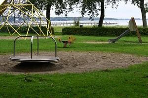 Playground with Merry-Go-Round and Lake View photo