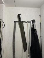 Machete Mounted on Wall in Storage Area photo