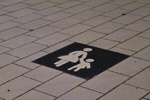 Mother and Child Symbol on Pavement photo