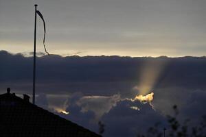 Dramatic Sunset with Rays of Light and Danebrog photo