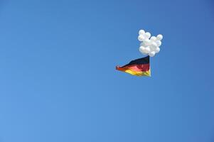 German Flag with Balloons in Clear Sky photo