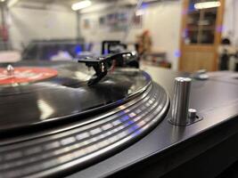 Close Up of a Spinning Vinyl Record on a Turntable photo