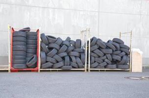 Stack of Used Tires on Metal Racks photo