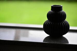 Elegant Black Ribbed Vase on Countertop photo