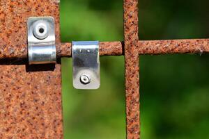 Close-up of a Rusty Metal Gate Latch and Hinge photo