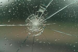 A broken window with rain drops on it photo