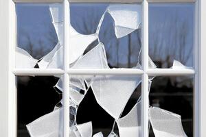 A broken window with a broken pane of glass photo