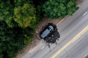 An aerial view of a car that is stuck in the middle of a road photo