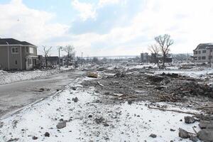 A street that is covered in snow and debris photo