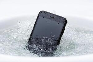 A cell phone is submerged in water photo