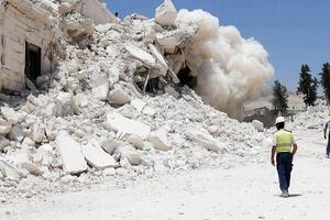 A man walks past a pile of rubble in the middle of a city photo