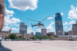 A man looking at a helicopter flying over a city photo