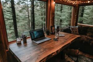 A laptop sits on a desk in front of a window photo