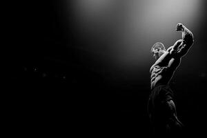 A man is standing in the dark with his arms out photo