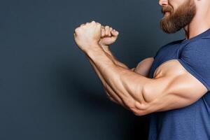 A man with a beard and muscles flexing his arms photo
